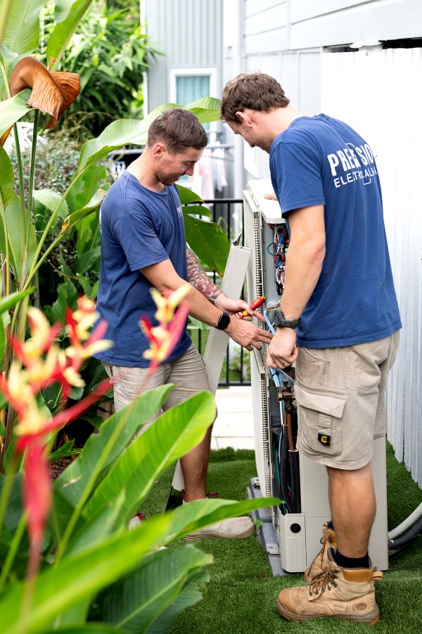 Electrician servicing a hot water system