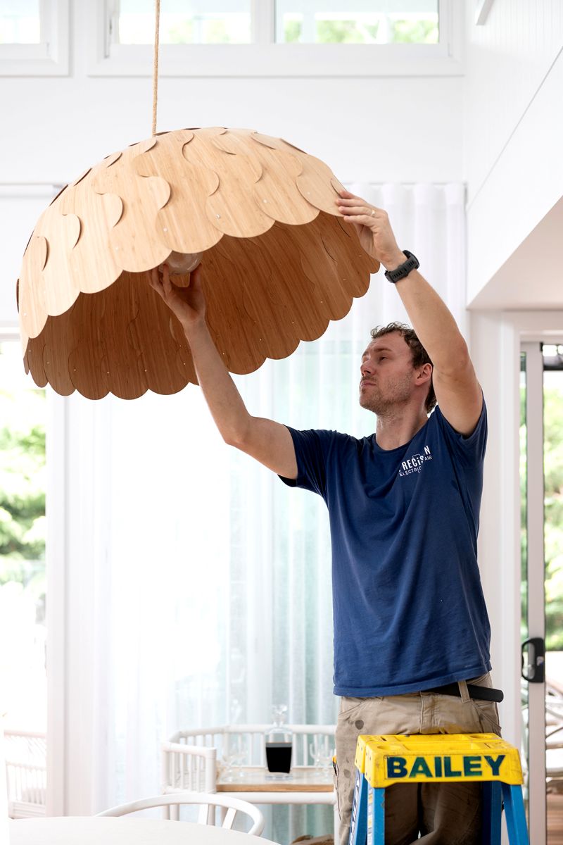 Precision Electrical & Air electrician installing a feature pendant light