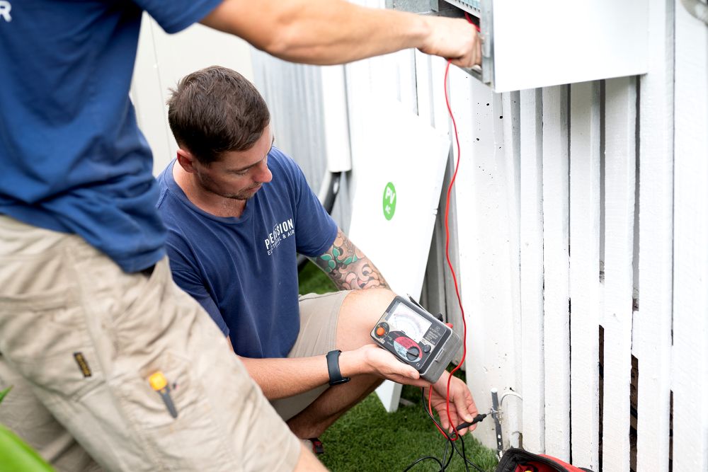 Precision Electrical & Air electrician working on a home switchboard and meter box in Brisbane