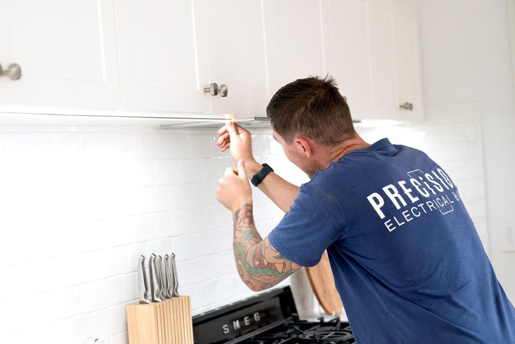 Electrician installing a light fitting
