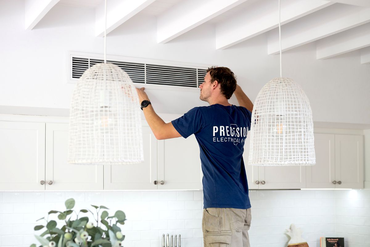 Technician installing a split system air conditioner