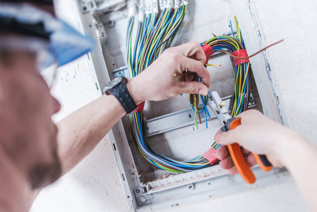 Electrician wiring a switchboard