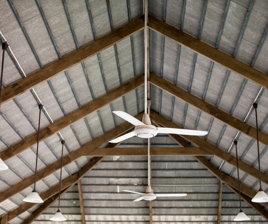 Ceiling fan installed under a high timber-beamed ceiling