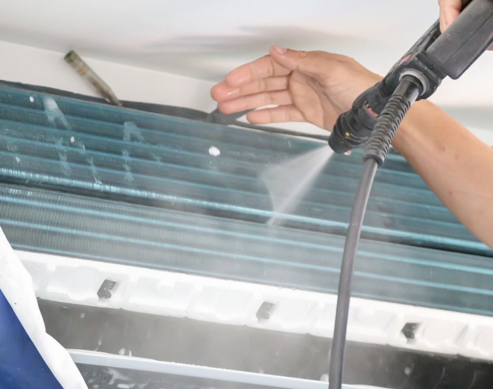 Air conditioner coil being cleaned
