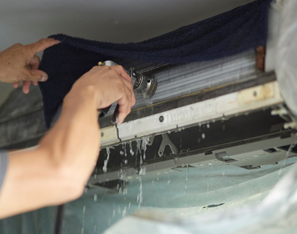 Dirty water draining from an air conditioner during a deep clean