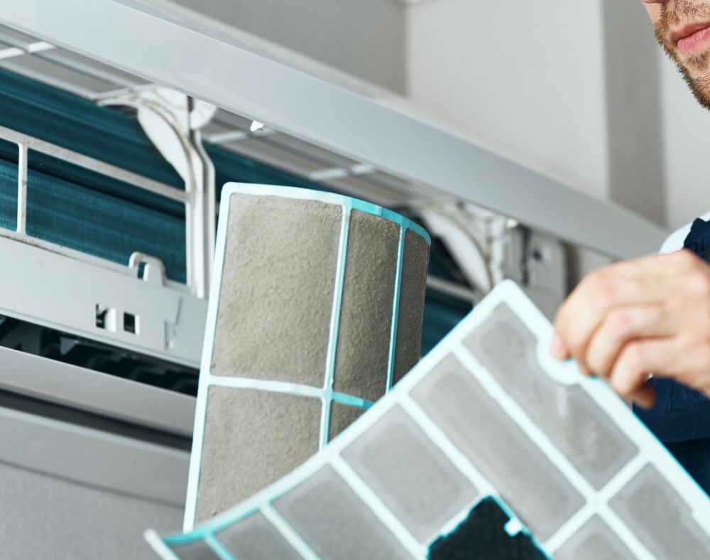 Air conditioner filter being cleaned